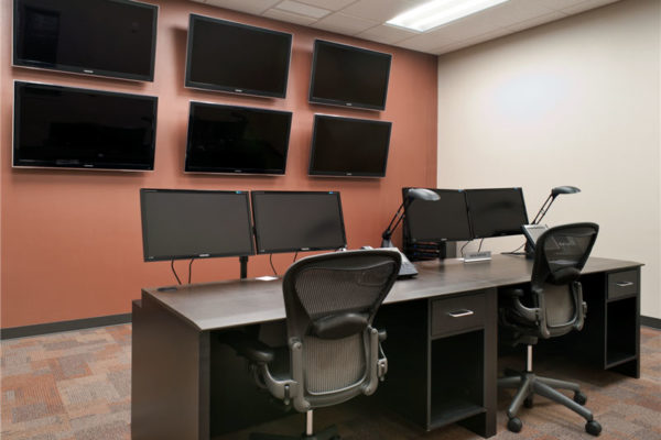 workstations with additional video display on wall
